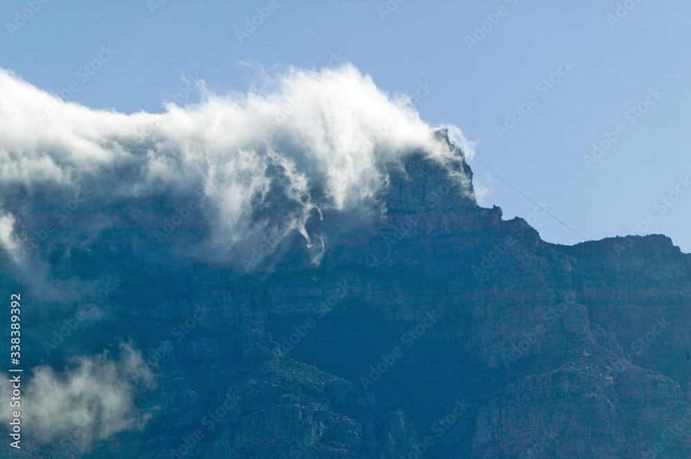 Clouds blow over Table Mountain and mountains behind Cape Town, South Africa