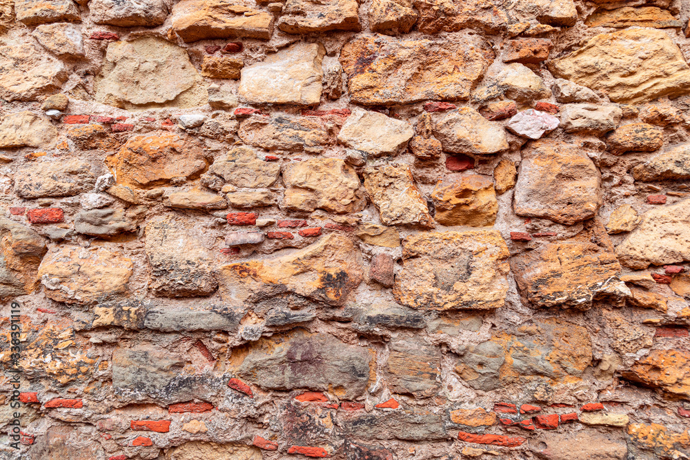 Texture of antique masonry wall. Texture of a stone wall. (Multi-colored bricks) Texture of antique masonry wall. Texture of a stone wall. (Multi-colored bricks)