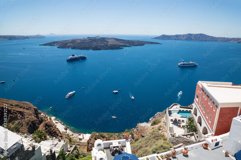 View from the city of Fira on the caldera with tourist ships, cruise liners. Santorini, Greece