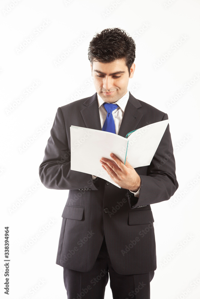 Business man wearing suit reading annual audit report happy with results