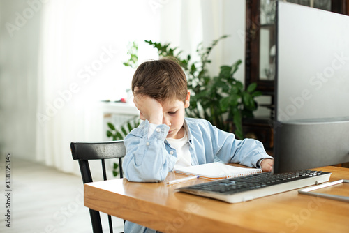 Kids and gadgets. Distance learning during isolation during quarantine in coronavirus. Boy and laptop at home. Lifestyle. Lockdown and Social Distancing