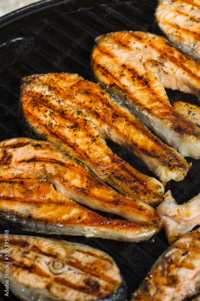 Grilled fish, salmon steaks on a grill pan, outdoor