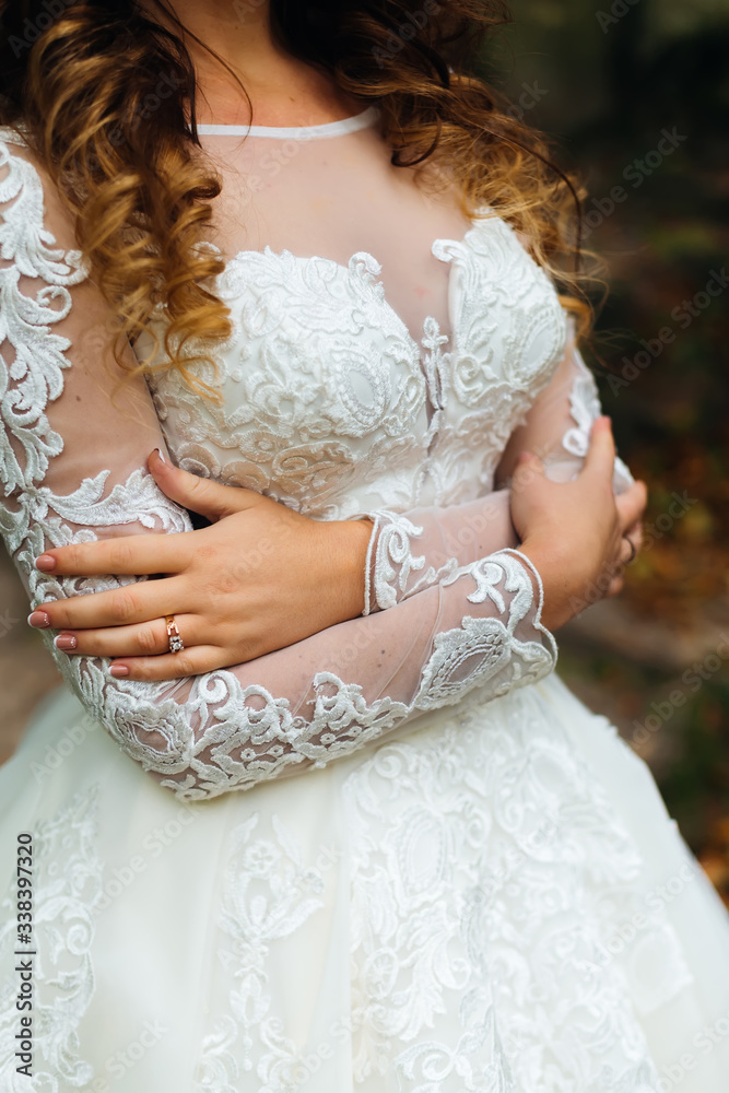 close-up of wedding dress on the bride who embrace himself