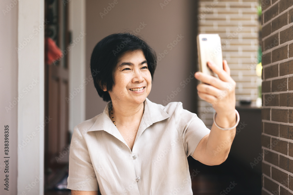 Elder smile woman use smartphone selfie photo for social network Elder smile woman use smartphone selfie photo for social network
