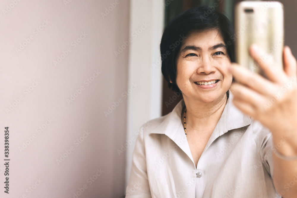 Elder smile woman use smartphone selfie photo for social network Elder smile woman use smartphone selfie photo for social network