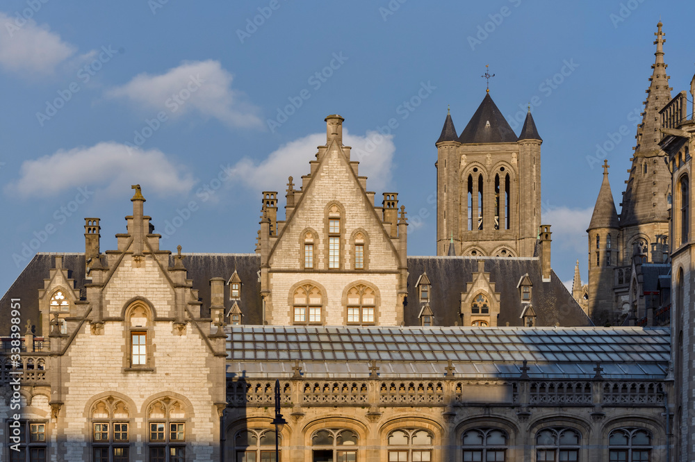 Ghent, Flemish Region / Belgium - april 24 2012 : the Façades of the Graslei, and the Gothic St Bavo's Cathedral in Ghent, Belgium Ghent, Flemish Region / Belgium - april 24 2012 : the Façades of the Graslei, and the Gothic St Bavo's Cathedral in Ghent, Belgium