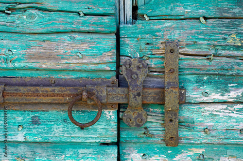 Rusty old Door bolt on an old door 