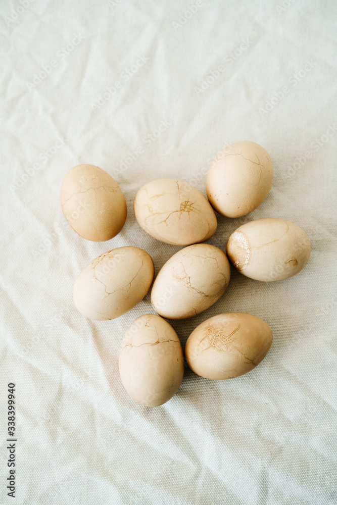 Fototapeta premium Seven Easter eggs trendy pastel colored with cracks lie on the table on a light tablecloth. top view. minimal style. easter concept.copy space for text