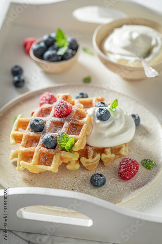Delicious and homemade waffles with berries and whipped cream