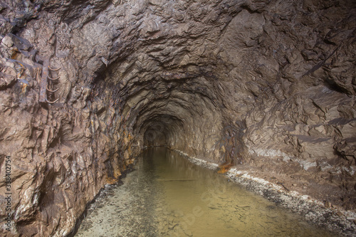 Underground abandoned bauxite ore mine tunnel with water