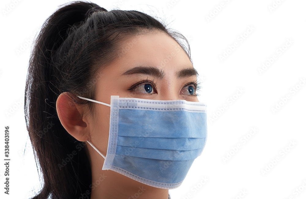 Beautiful young Asia woman putting on a medical mask to protect from airborne respiratory diseases as the flu covid-19 PM2.5 dust and smog, Women safety virus infection concept Beautiful young Asia woman putting on a medical mask to protect from airborne respiratory diseases as the flu covid-19 PM2.5 dust and smog, Women safety virus infection concept