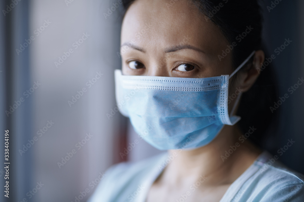 Woman staying at home wearing protective surgical mask Woman staying at home wearing protective surgical mask