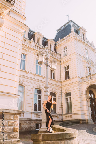 building with beautiful architecture and girl in black dress nea