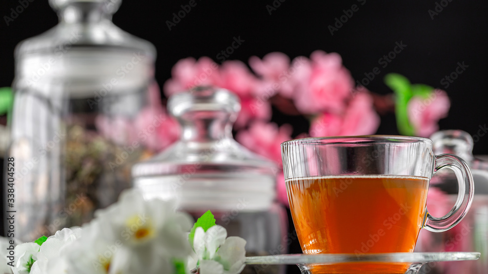 Tea pouring closeup. Tea being poured into glass transparent tea cup. Tea time concept. Transparent glass teapot and teacup. Herbal tea, green tea, tea with Jasmine. Put the sugar in a Cup and stir. Tea pouring closeup. Tea being poured into glass transparent tea cup. Tea time concept. Transparent glass teapot and teacup. Herbal tea, green tea, tea with Jasmine. Put the sugar in a Cup and stir.