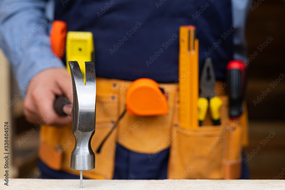 Carpenter's hands measuring plank Carpenter's hands measuring plank