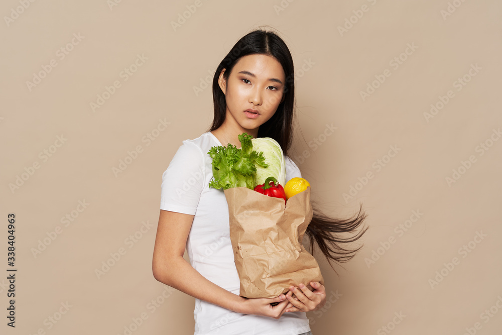 young woman holding a bunch of vegetables young woman holding a bunch of vegetables