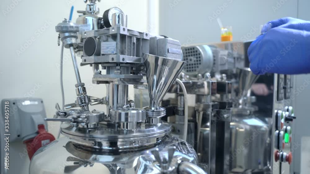Factory worker loading pouring chemical liquid into medicine production machine Spbas. Process of medicaments production at pharmacological factory, plant, laboratory Factory worker loading pouring chemical liquid into medicine production machine Spbas. Process of medicaments production at pharmacological factory, plant, laboratory