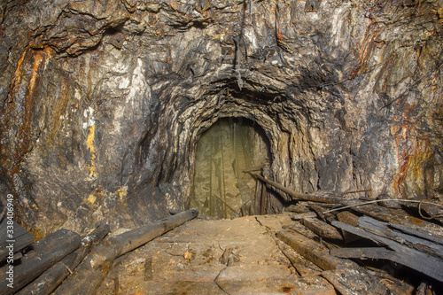 Fototapeta Naklejka Na Ścianę i Meble -  Underground abandoned bauxite ore mine tunnel incline shaft