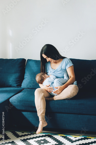 Mother is breast-feeding her son. The concept of breast-feeding, communication between mother and child, lactation, motherhood, stay home.