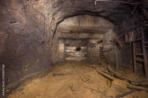 Underground abandoned bauxite ore mine tunnel with broken wall