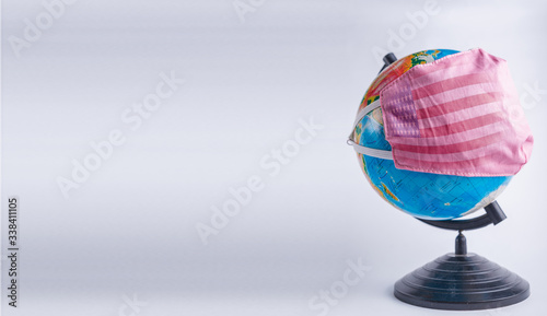Globe in a medical mask with the USA flag. America pandemic concept