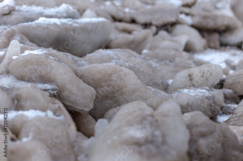 Close up shot of small frozen blocks of sand on a beach on a very cold day