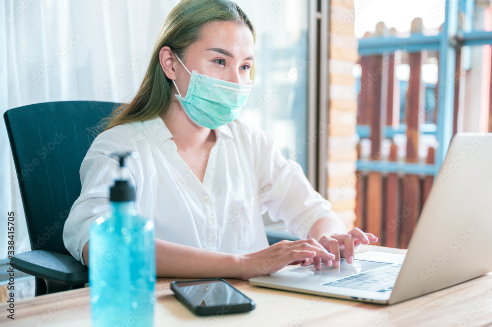 Coronavirus. Young business woman working from home wearing protective mask. Business woman in quarantine for coronavirus wearing protective mask. Working from home with sanitizer gel. Coronavirus. Young business woman working from home wearing protective mask. Business woman in quarantine for coronavirus wearing protective mask. Working from home with sanitizer gel.