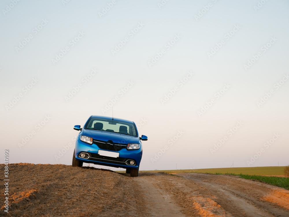 Belarus blue car in a field in spring at sunrise Belarus blue car in a field in spring at sunrise