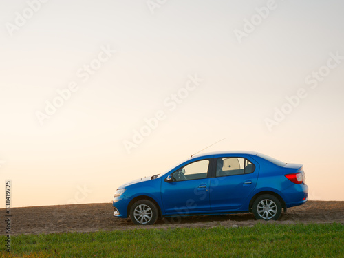 Belarus blue car in a field in spring at sunrise © makam1969