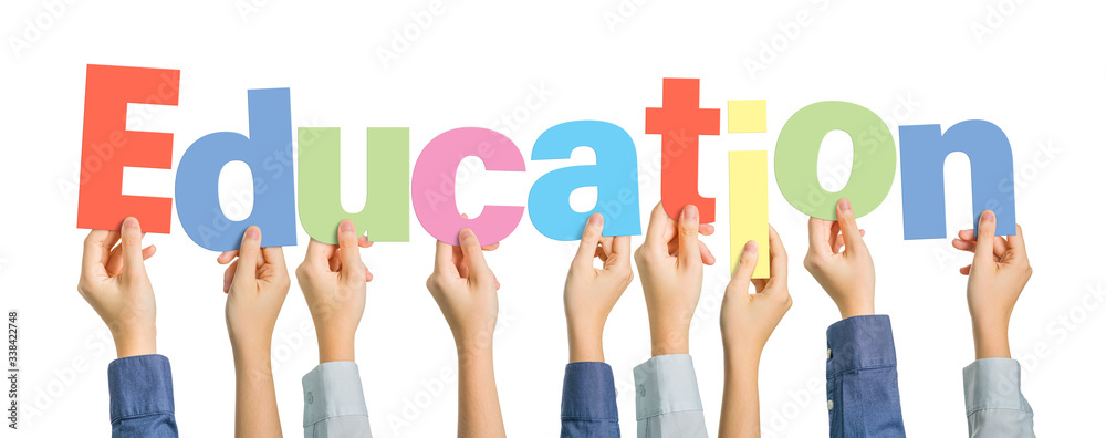 Multiple hands holding alphabets to form the word Education on white background Multiple hands holding alphabets to form the word Education on white background