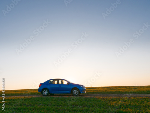 Belarus blue car in a field in spring at sunrise © makam1969