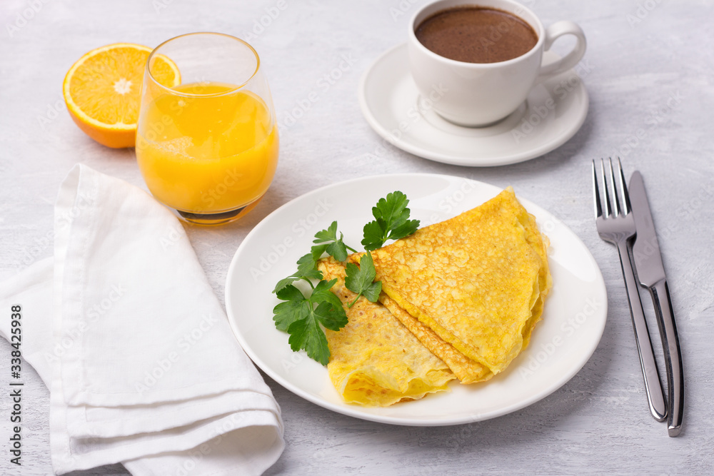 Keto breakfast high-fat low-carb, pancakes without flour and nuts, ketocoffee (bulletproof) with coconut oil, freshly squeezed orange juice and orange on a light gray background Keto breakfast high-fat low-carb, pancakes without flour and nuts, ketocoffee (bulletproof) with coconut oil, freshly squeezed orange juice and orange on a light gray background