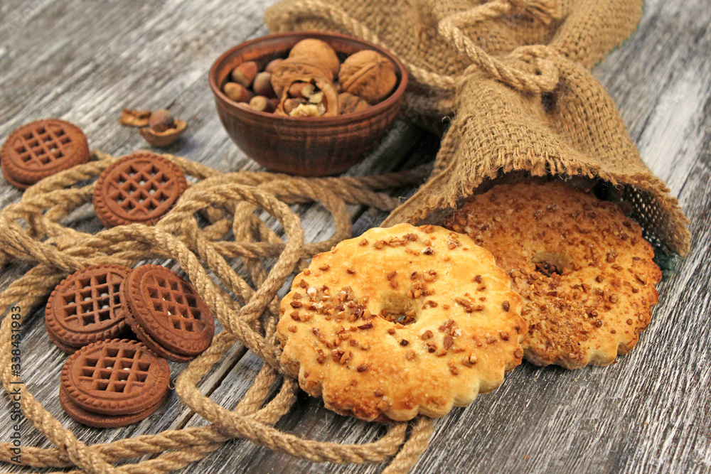 Golden cookies with nuts on a wooden table, rustic pastry concept Golden cookies with nuts on a wooden table, rustic pastry concept