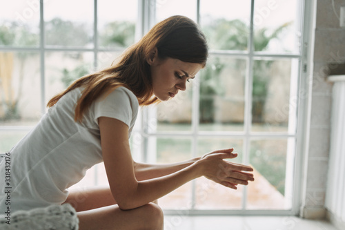 young woman looking through window Free Download young woman looking through window - GFXLoad