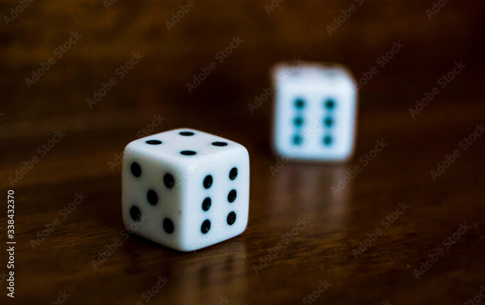 Die/Dice on Backgammon board game - dark mahagoni wood, shadows - casino Die/Dice on Backgammon board game - dark mahagoni wood, shadows - casino
