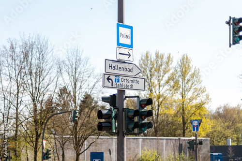 Street sign showing police, city center and indoor swimming pool in Rahlstedt