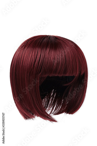 Subject shot of a natural look bricky-coloured wig with bangs. The short blunt bob wig is isolated on the white background. 