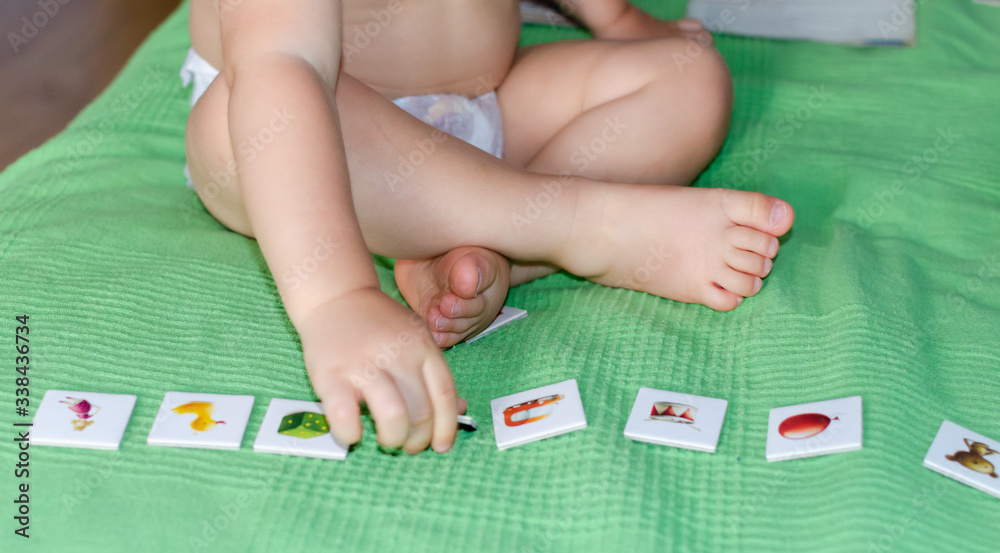 Child lining up toys on the floor at home. Kids education concept. . Child lining up toys on the floor at home. Kids education concept. .