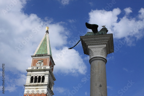 St Mark's column in Venice against a blue sky with white clouds