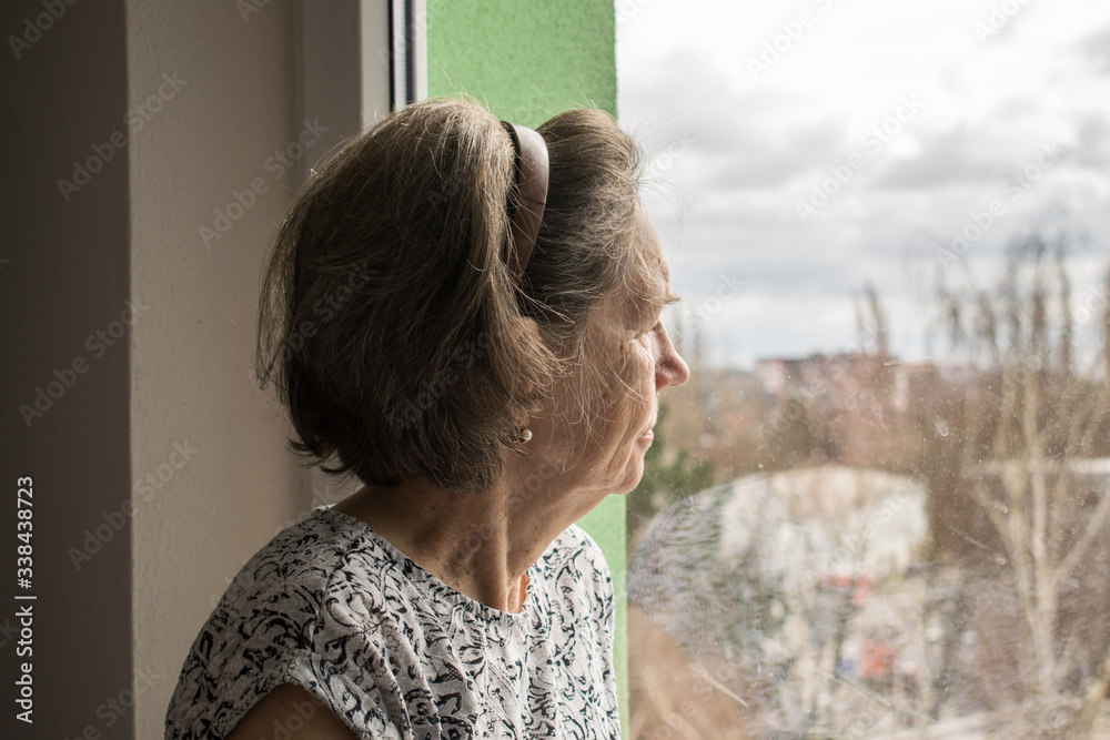 sad lonely old woman look next to window allone depressed abandoned coronavirus stay home sad lonely old woman look next to window allone depressed abandoned coronavirus stay home