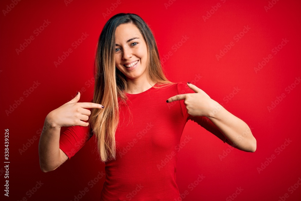 Young beautiful blonde woman with blue eyes wearing casual t-shirt over red background looking confident with smile on face, pointing oneself with fingers proud and happy. Young beautiful blonde woman with blue eyes wearing casual t-shirt over red background looking confident with smile on face, pointing oneself with fingers proud and happy.