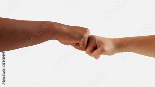 fist clash between male hand and female hand with different skin tones on white isolated
