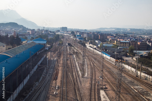 Perspective view on many railway track lines, Old platform and freight train nearby. Railroad background.