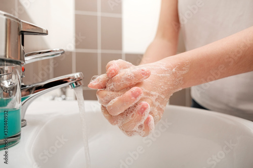 Washing hands with soap under the faucet with water for coronavirus prevention, hygiene to stop spreading coronavirus. Hygiene concept, Hygiene sanitary, clean, wash, disinfect hygienic human.