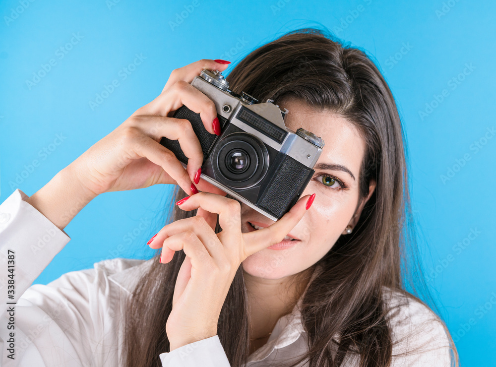 girl with a camera on a blue background girl with a camera on a blue background