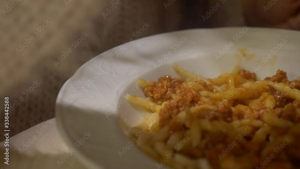 Woman eating pasta with meat ragù from a plate close up slide scene Woman eating pasta with meat ragù from a plate close up slide scene