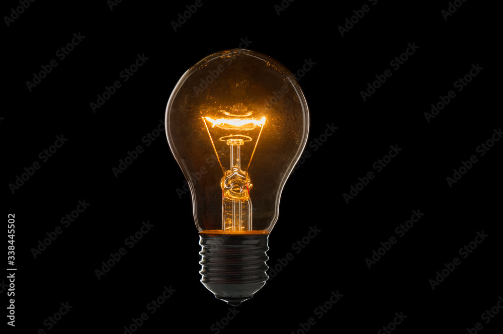 Old, dirty light bulb close up on black background - obrazy, fototapety, plakaty 