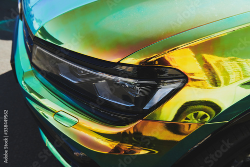 Chameleon holographic colour car. Front view closeup. Modern LED headlights. Car wrapping. Car exhibition.