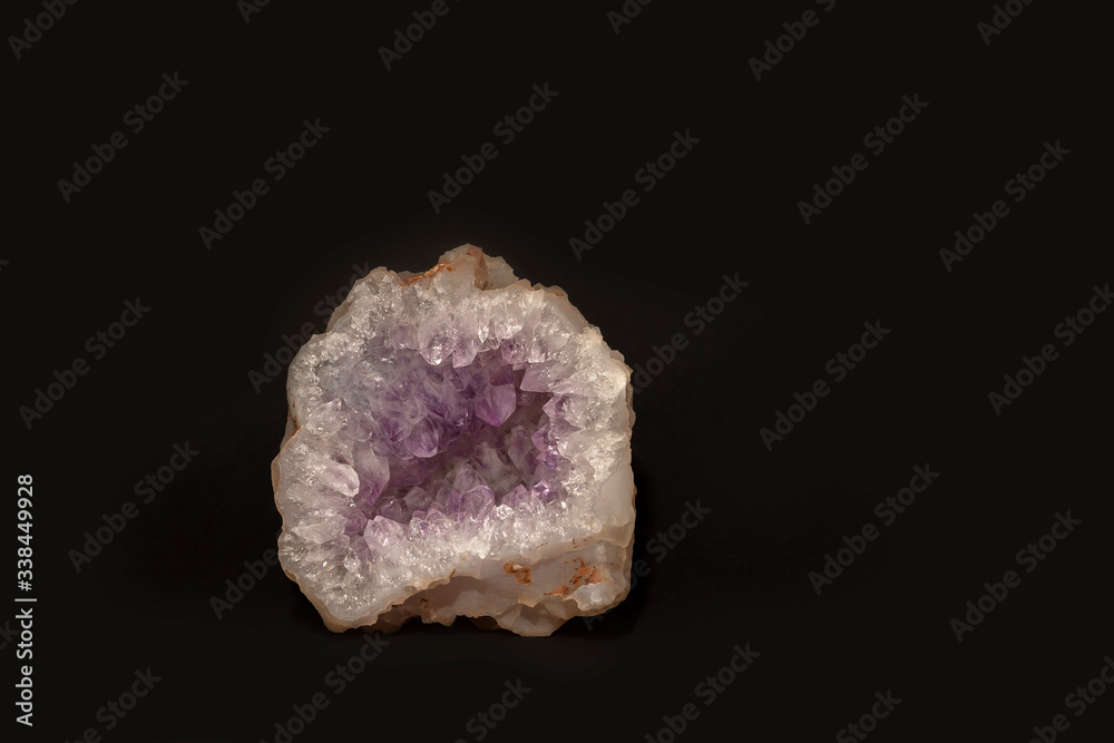 Untreated mineral amethyst quartz is a soft lilac color, isolated on a black background. Semiprecious stone. House decoration Untreated mineral amethyst quartz is a soft lilac color, isolated on a black background. Semiprecious stone. House decoration