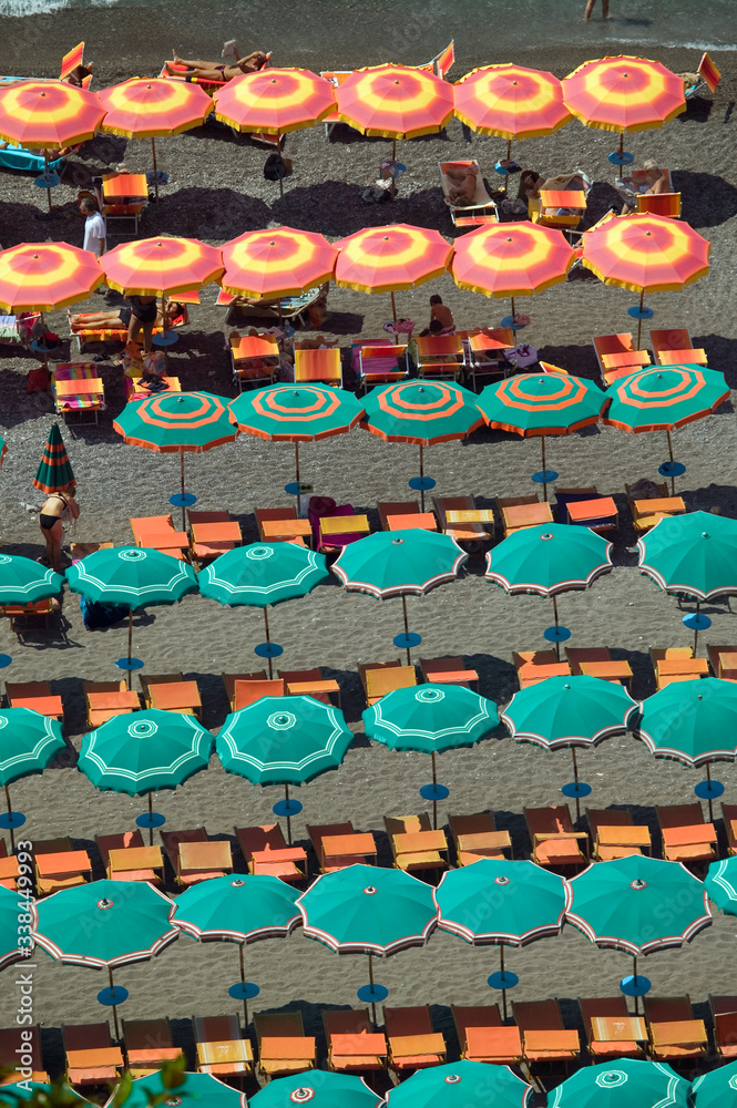 Elevated pattern view of famous beach umbrellas of Amalfi, a town in the province of Salerno, in the region of Campania, Italy, on the Gulf of Salerno, 24 miles southeast of Naples